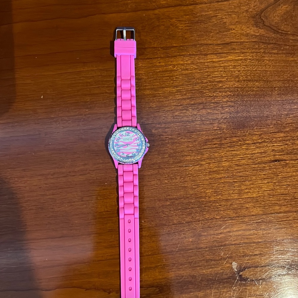 Hot pink watch with rhinestones around the watch face